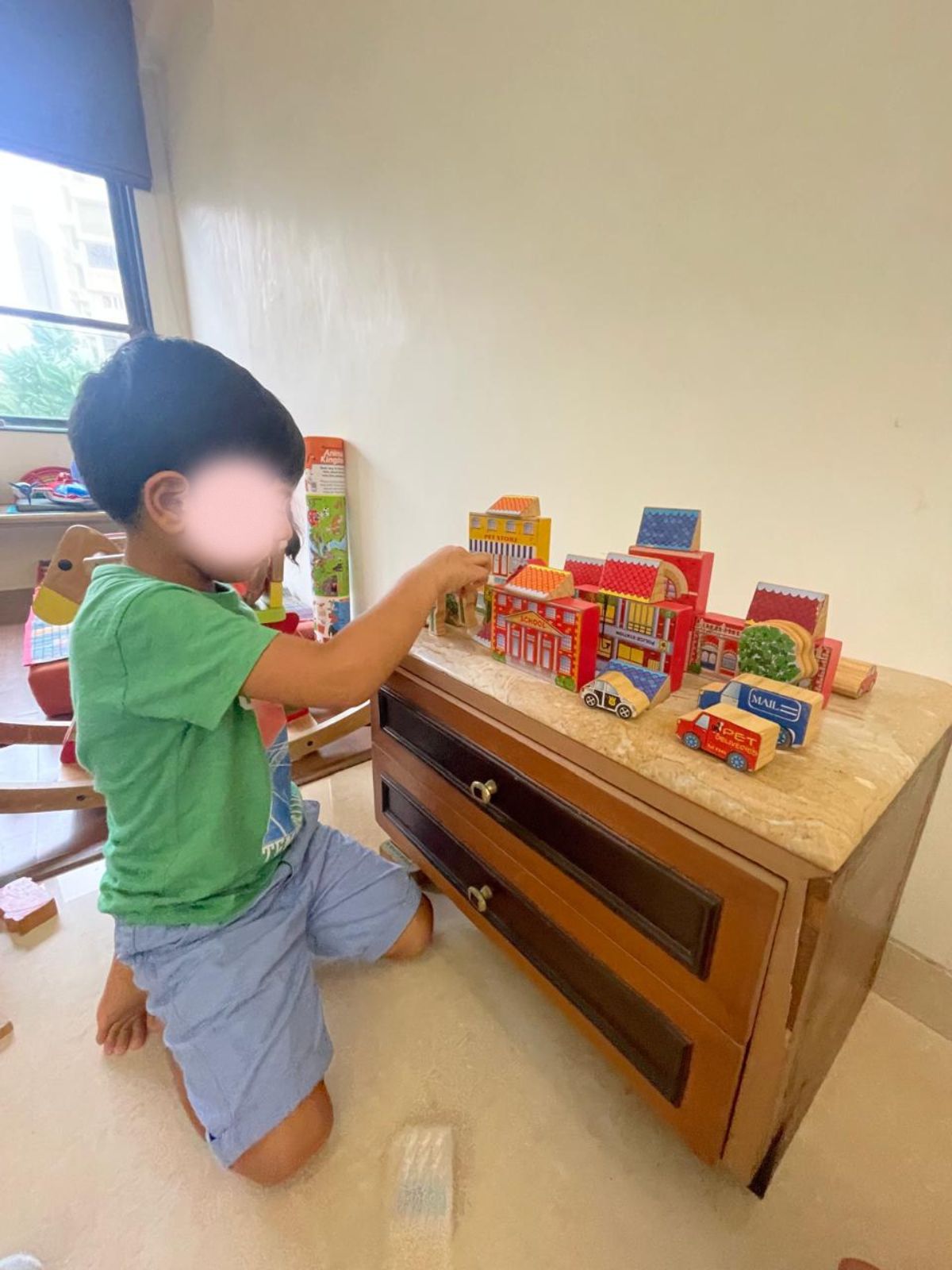 Young child engaged in creative play with building blocks